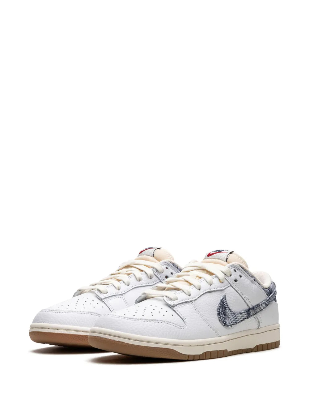 White low-top sneakers with navy swoosh, lace-up closure, and gum sole