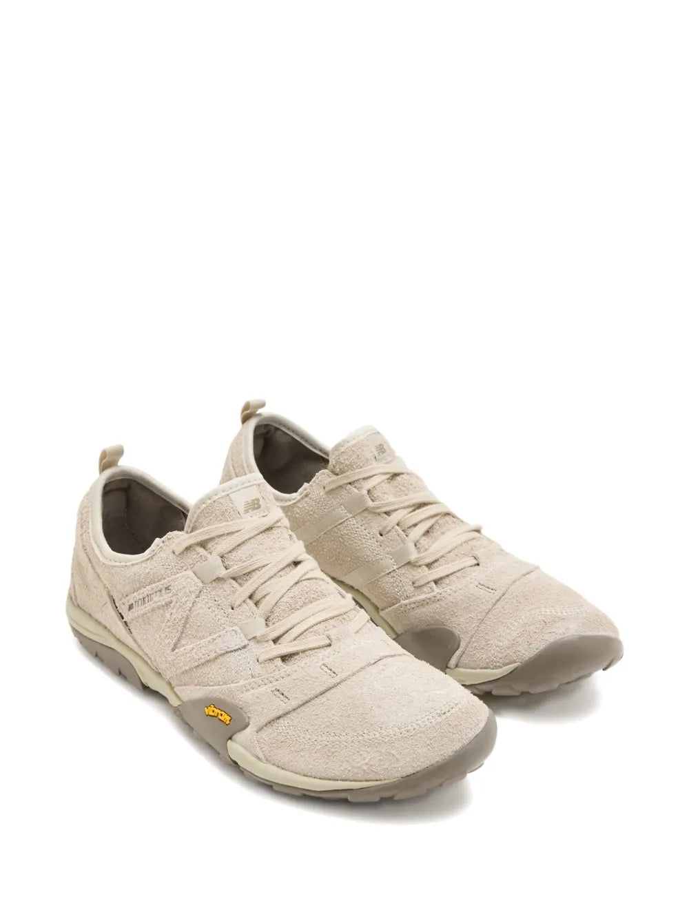 Beige New Balance suede lace-up sneakers, side view with rubber outsole