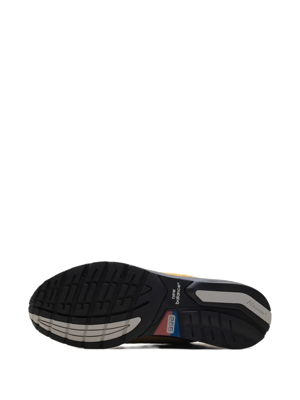 New Balance 992 sneaker outsole with black tread and gray sections, blue side detail