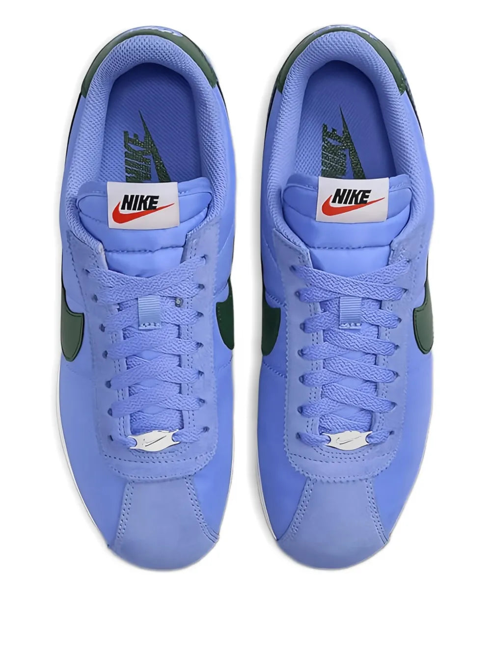 Blue lace-up sneakers with Nike tongue label, green heel accents, white soles