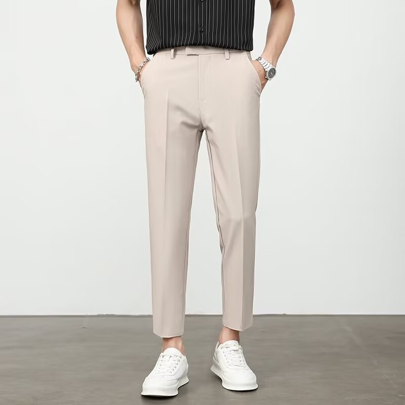 Men's khaki dress pants with belt loops, flat front, and tapered ankle length