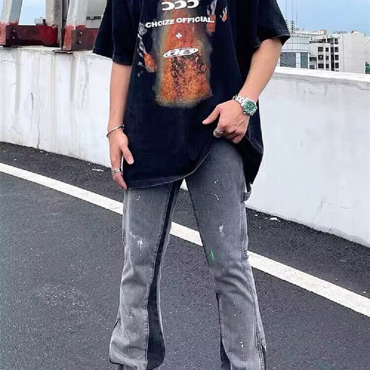 Gray distressed denim jeans with paint splatter and straight wide-leg fit