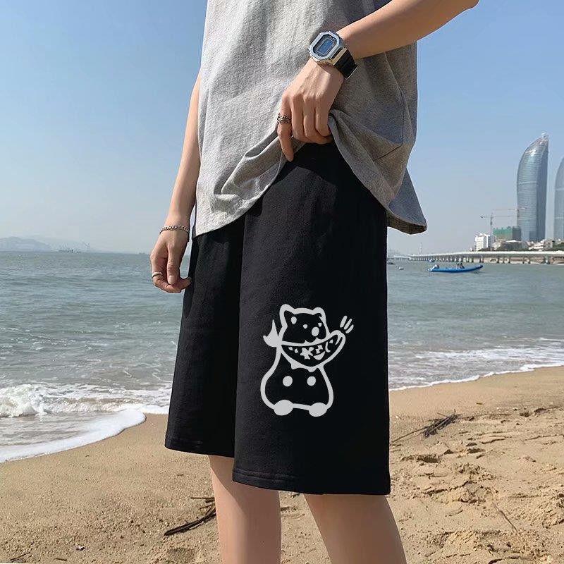 Black straight sports shorts with white cartoon cat graphic on the front leg, knee length.