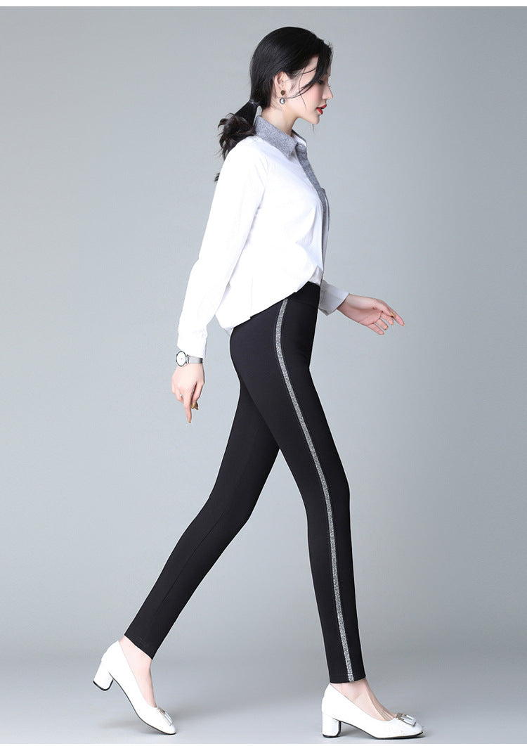 Black pants with white side stripes, angled walking view, ankle length
