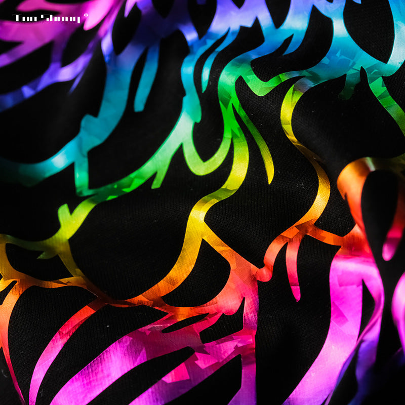 Close-up of colorful flame-style neon print on black T-shirt fabric