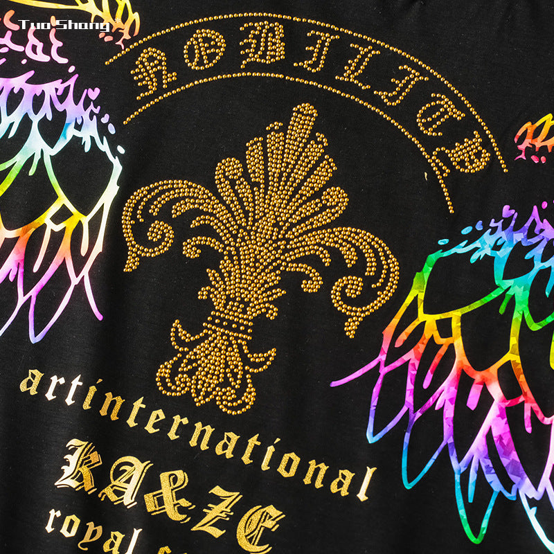 Black T-shirt close-up with gold rhinestone lion head and circular crest graphic