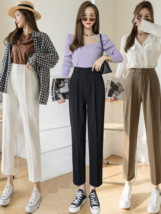 Black pipe pants with pleated front, belt loops, and button closure