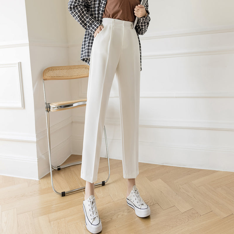 White pipe pants with belt loops, pleats, and button closure