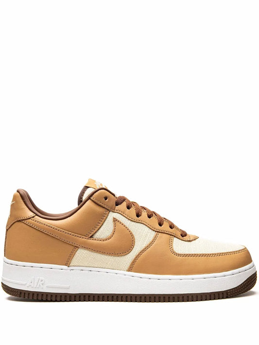 Low-top sneakers with tan leather panels, white Swoosh, and brown laces