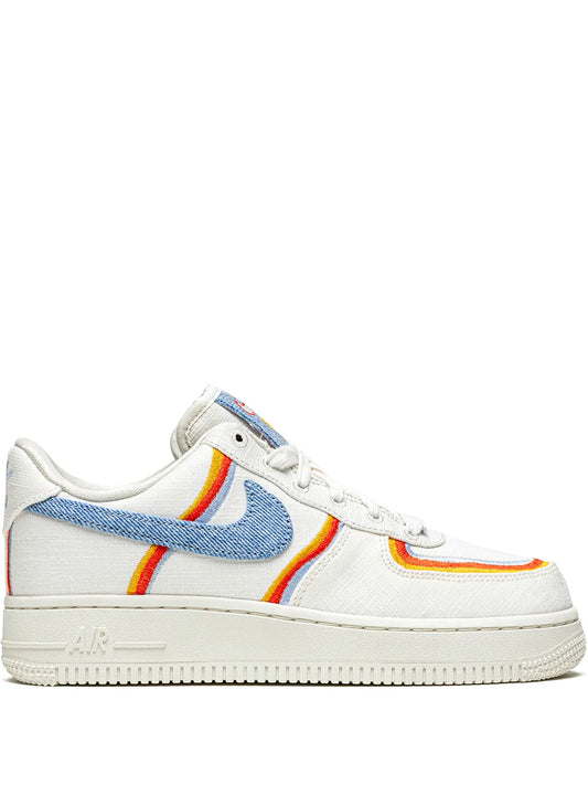 White low-top sneaker with blue swoosh and orange stripe accents