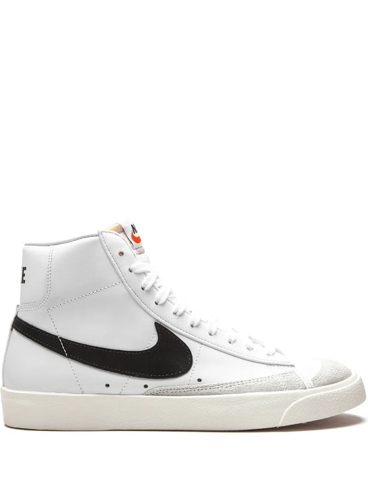 White mid-top sneakers with black Nike swoosh and lace-up front, cream outsole