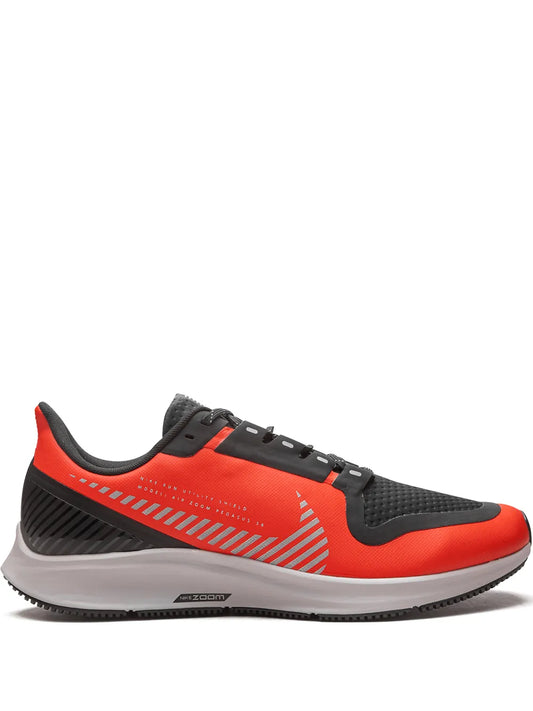 Nike shield running shoe in black and orange, lace-up with textured panels