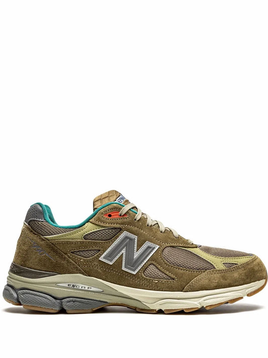 Dark brown suede sneaker with teal collar accents, large N logo, white midsole