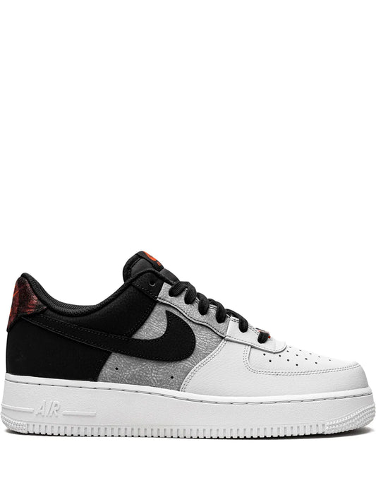 Black and white low-top sneakers with Nike swoosh and lace-up front