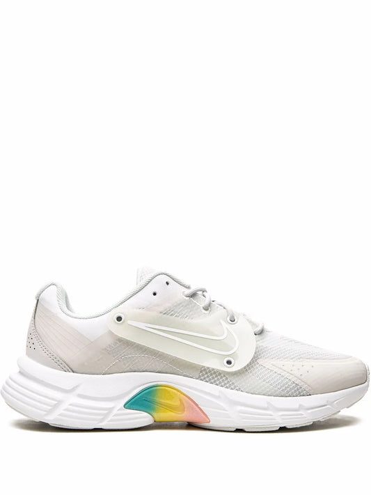 Nike white low-top sneakers with lace-up closure, mesh upper, and colorful midsole