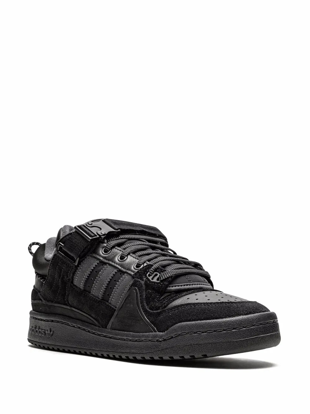 Black adidas low-top sneakers with buckle strap and lace-up front, rubber sole.
