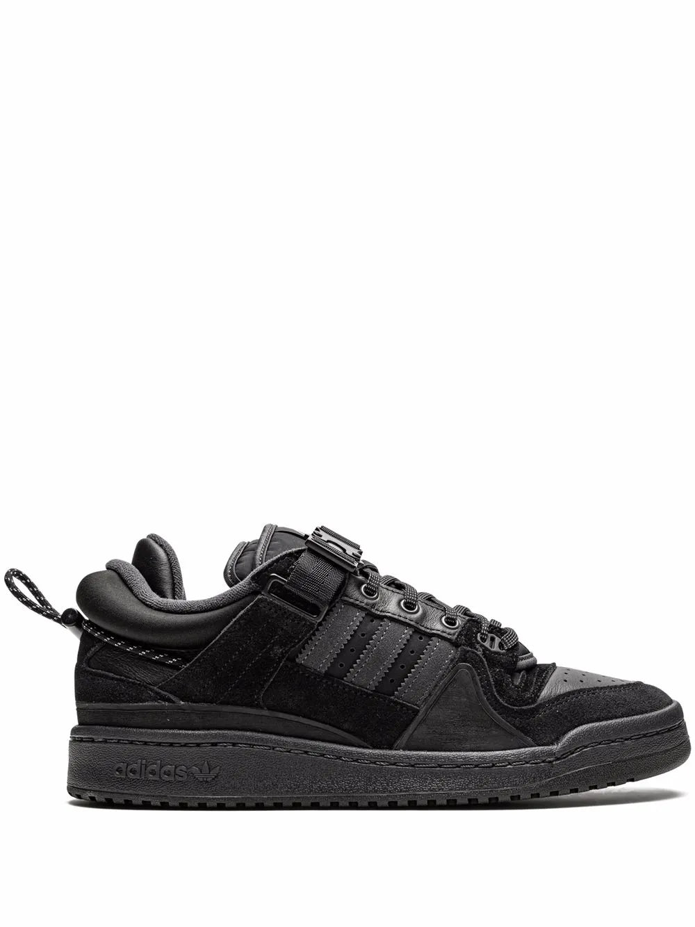 Black adidas low-top sneakers with buckle strap, lace-up, three-tone stripes.