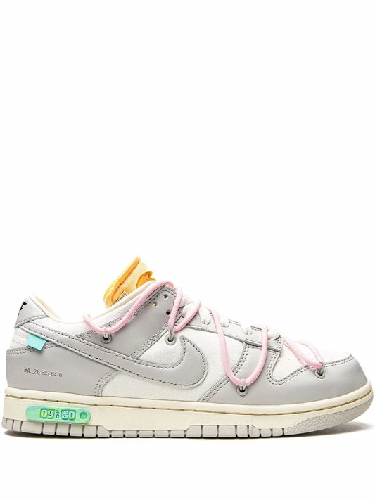 Low-top Nike Dunk sneaker in light gray leather with pink laces and white sole