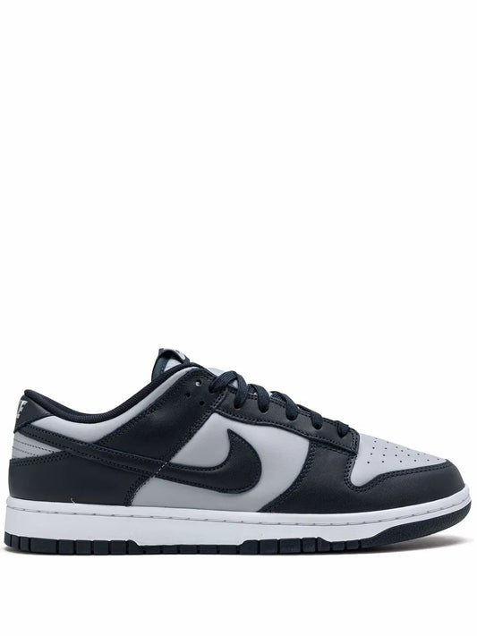 Black and white low-top sneakers with swoosh and lace-up closure