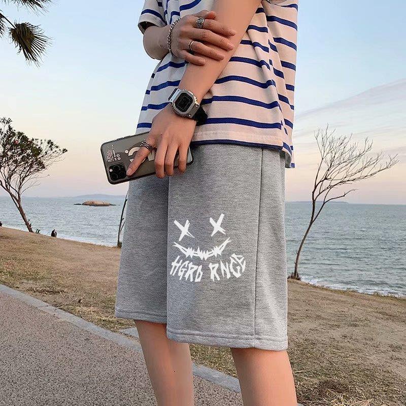 Light gray straight sports shorts with white X-eye monster graphic and stylized text.