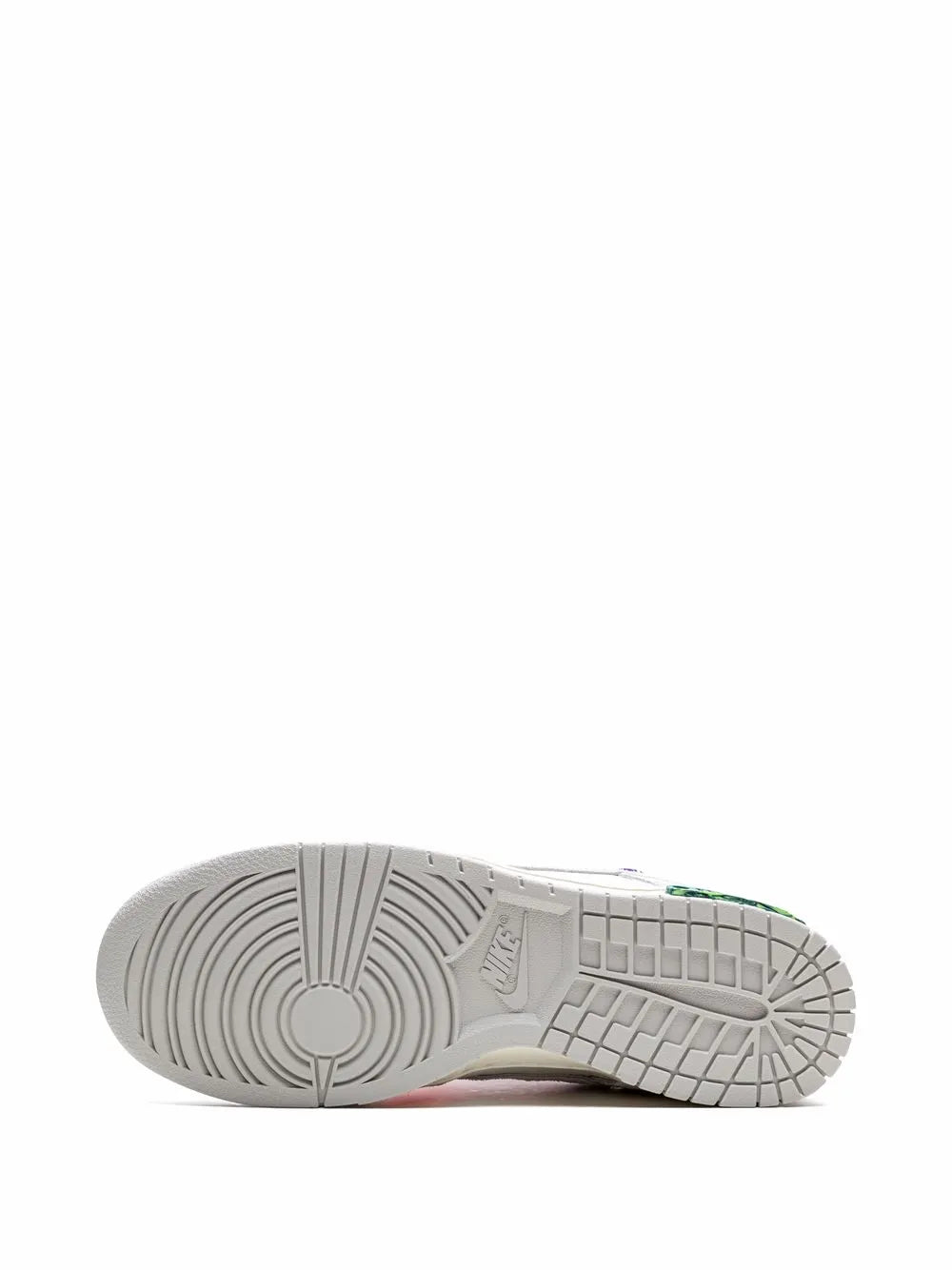 Light gray sneaker outsole with textured traction and green logo detail