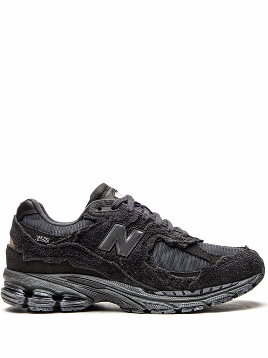 New Balance 2002R running sneaker in dark gray/black with N logo and lace-up front.