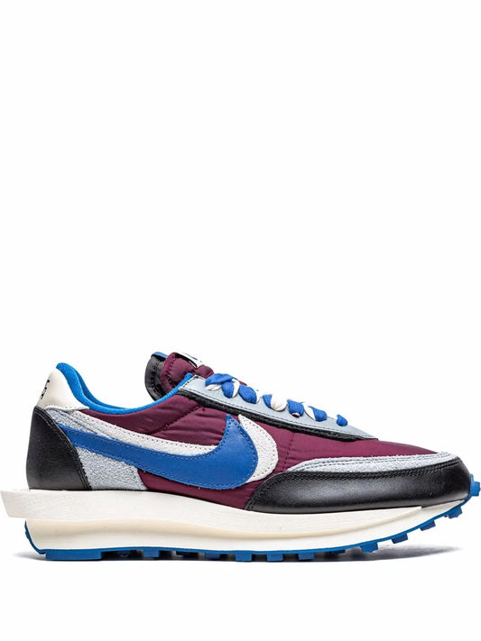 Colorblock sneaker with blue Swoosh, purple and black suede panels, white midsole