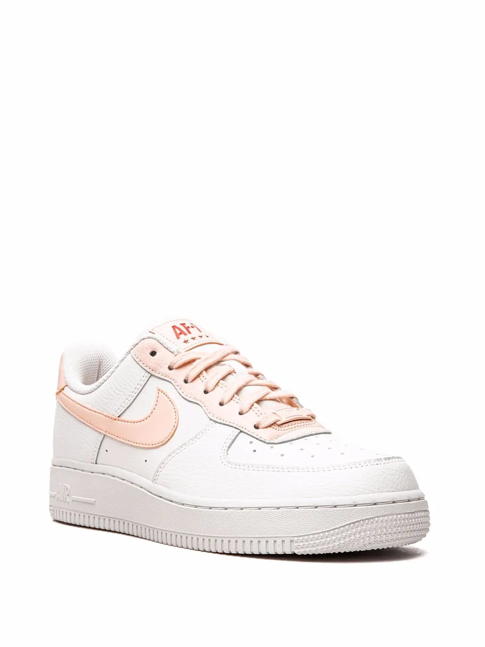 White low-top sneakers with pink laces and side swoosh