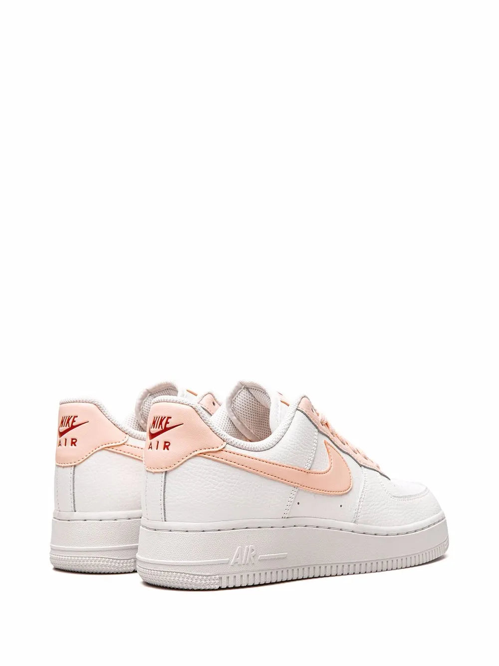 Pair of white low-top sneakers with pink heel tabs and swoosh