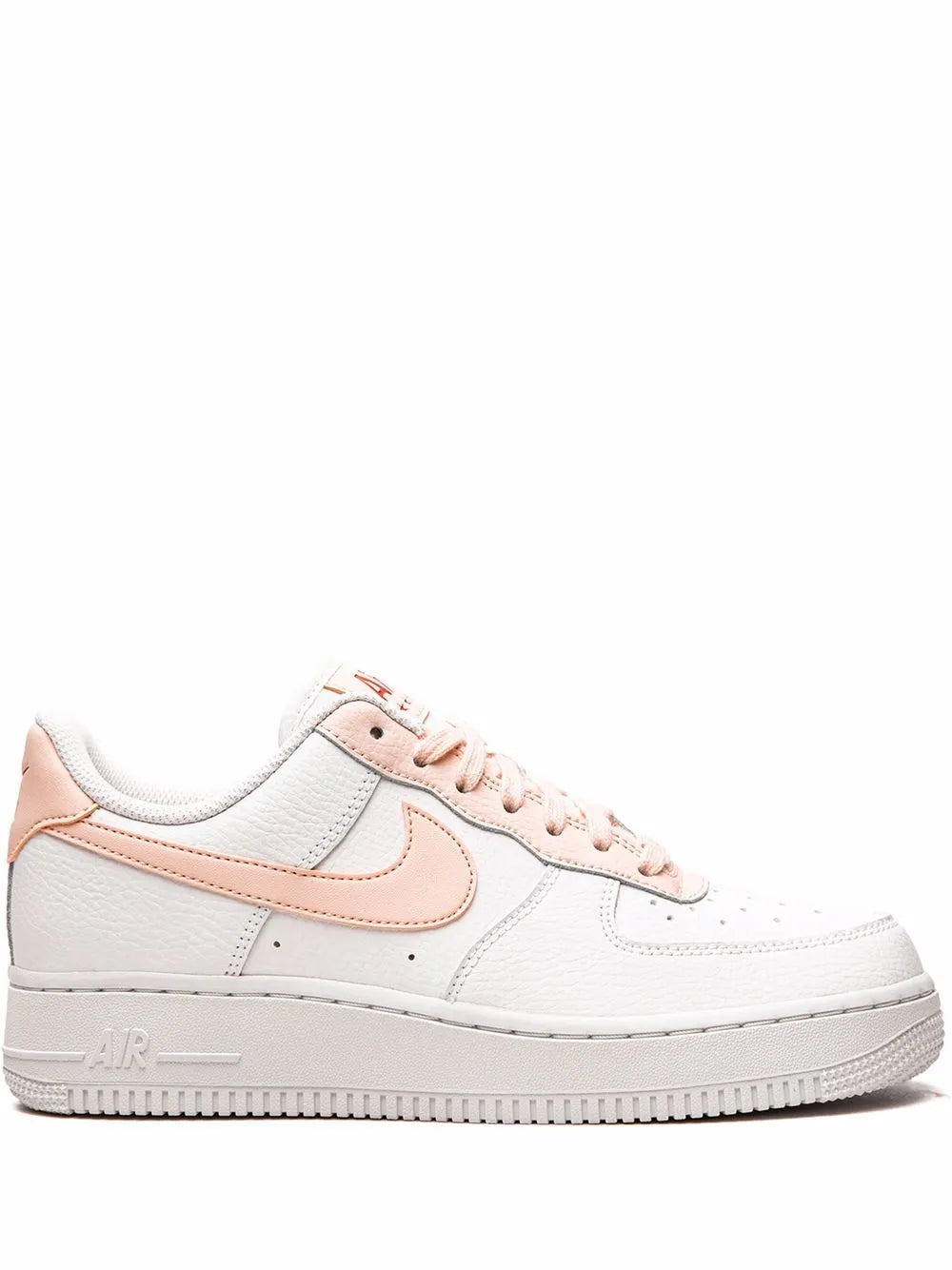 White low-top sneakers with pink swoosh and lace-up design