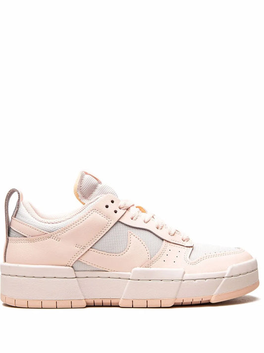 Nike low-top sneakers in light pink with white panels and lace-up closure