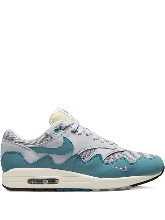 Air Max 1 sneaker in light gray and teal with visible air unit and cream sole