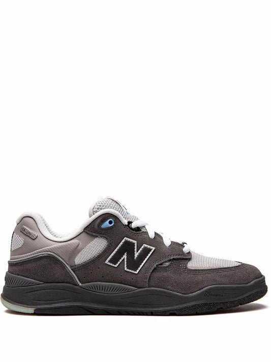New Balance 1010 low-top sneaker in dark gray with white laces and blue eyelets