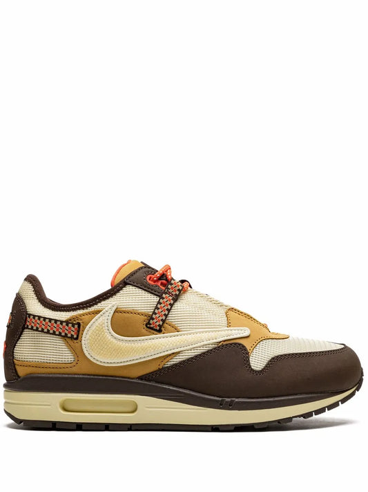 Nike Air Max 1 sneaker in cream, brown, and gold with orange lace accents