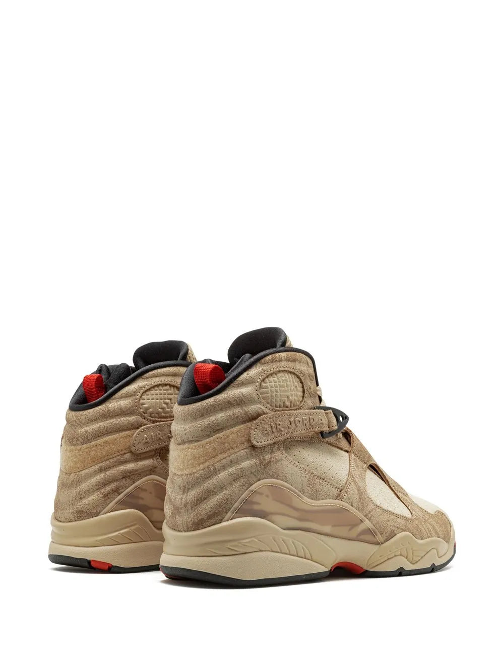 Beige Air Jordan 8 sneakers with black collar, red lining, and cushioned heel