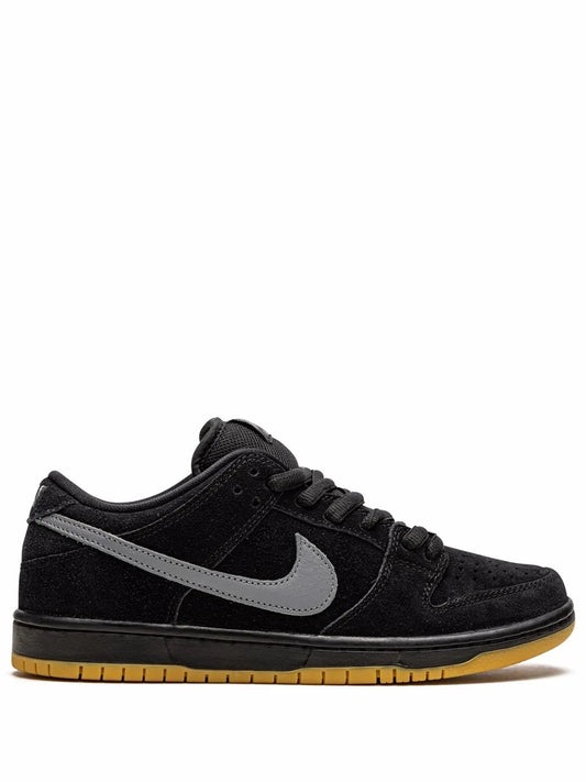 Nike SB black low-top skate sneakers with light gray swoosh and gum rubber sole