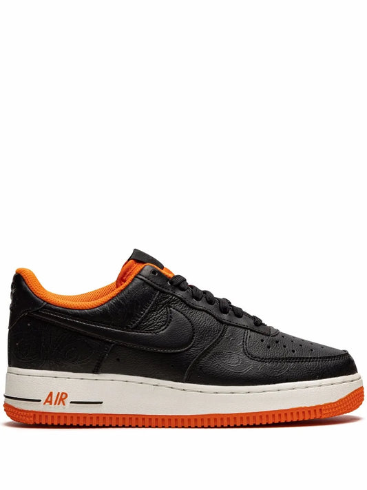 Nike low-top sneakers in black with orange inner lining, lace-up front, white midsole