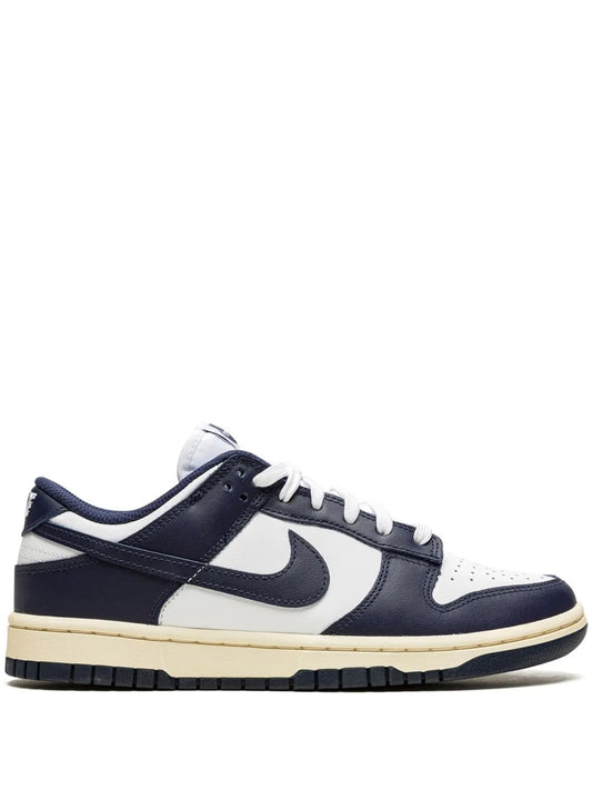 Nike Dunk Low low-top sneakers in white, navy, and gum sole