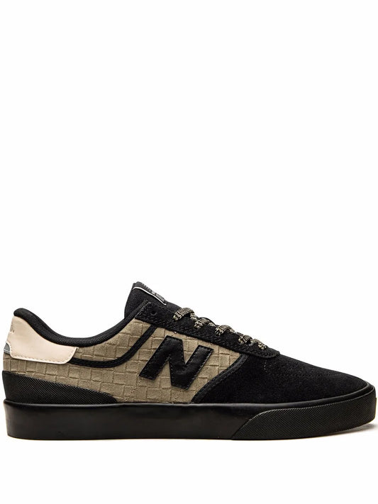 Beige and black low-top sneakers with New Balance “N” logo, lace-up design