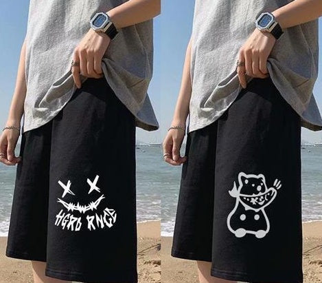 Black straight sports pants with white cartoon graphic on front