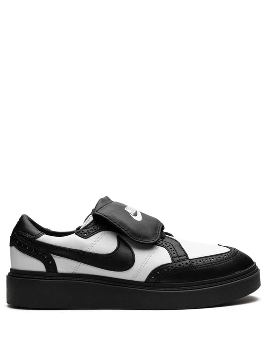 Black and white Nike low-top sneakers with velcro strap and rubber sole