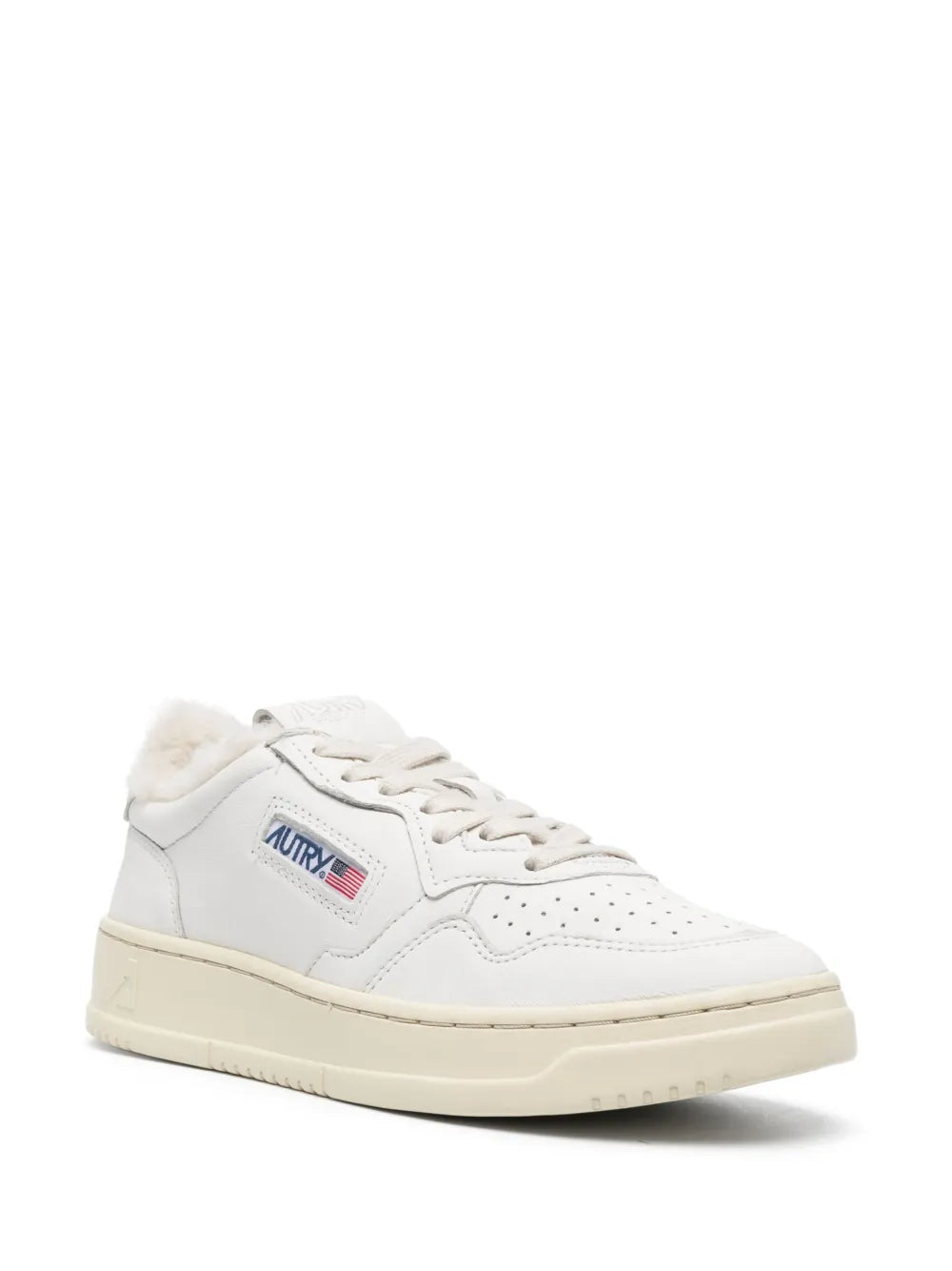 White low-top sneaker with lace-up front, perforated toe, and Autry logo patch