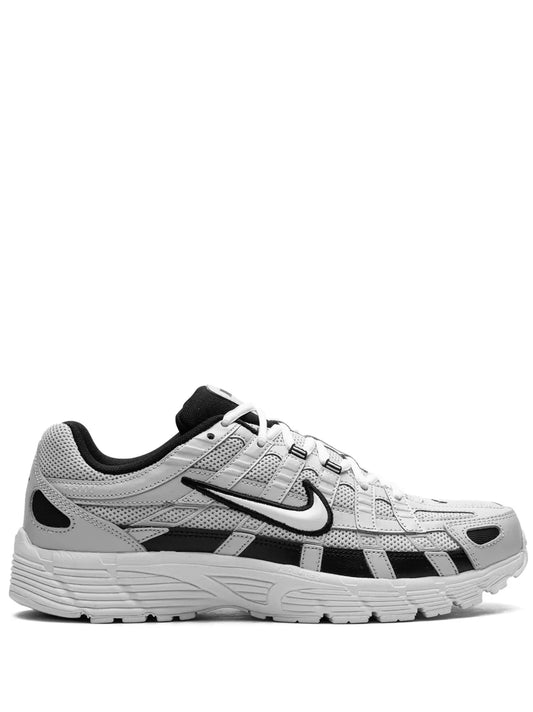 Nike P-6000 running shoe in light gray with black accents, lace-up front, cushioned sole