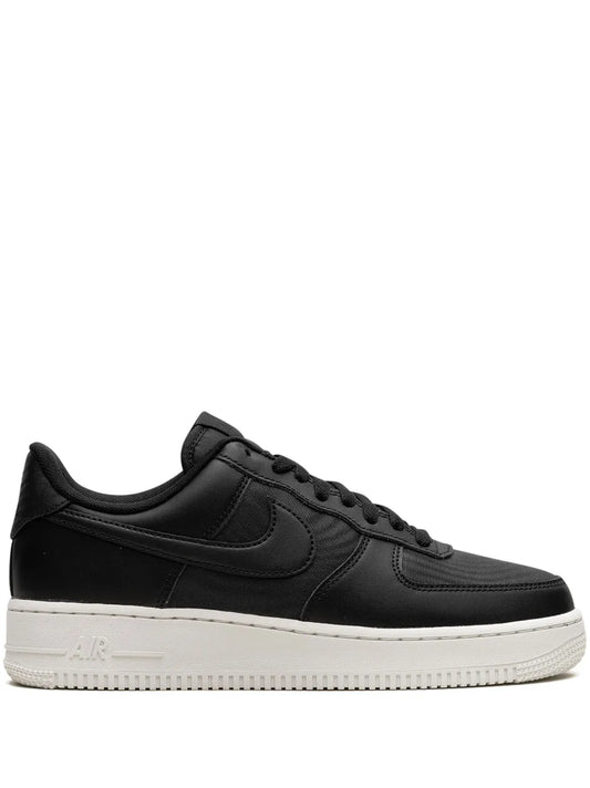 Nike Air Force 1 Low black leather sneakers, side view with white midsole