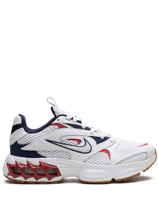 White and navy Nike Air Fire sneakers with red logo, lace-up, textured sole.