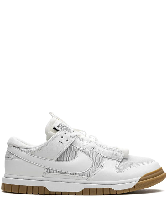 White Nike Air Dunk Jumbo sneaker with strap, Swoosh logo, and gum rubber outsole.