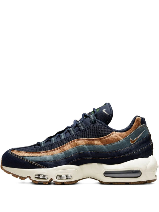 Nike Air Max 95 sneakers in dark navy with tan paneling and visible Air units