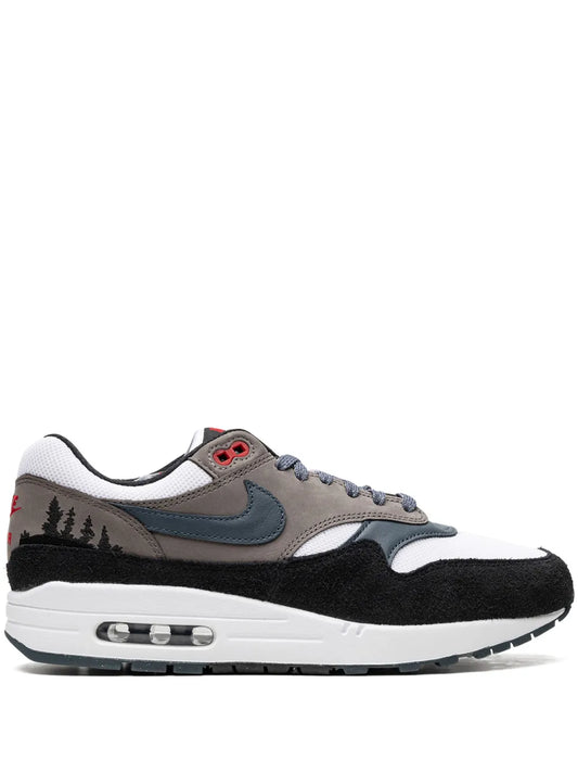 Nike Air Max 1 sneakers in white, black and gray, blue swoosh, visible red eyelet