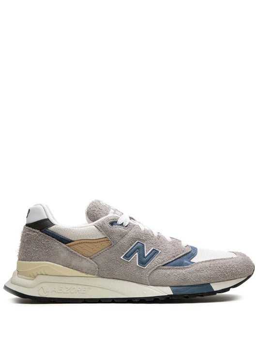 New Balance 998 sneakers in grey with blue N logo, tan heel accents, white laces
