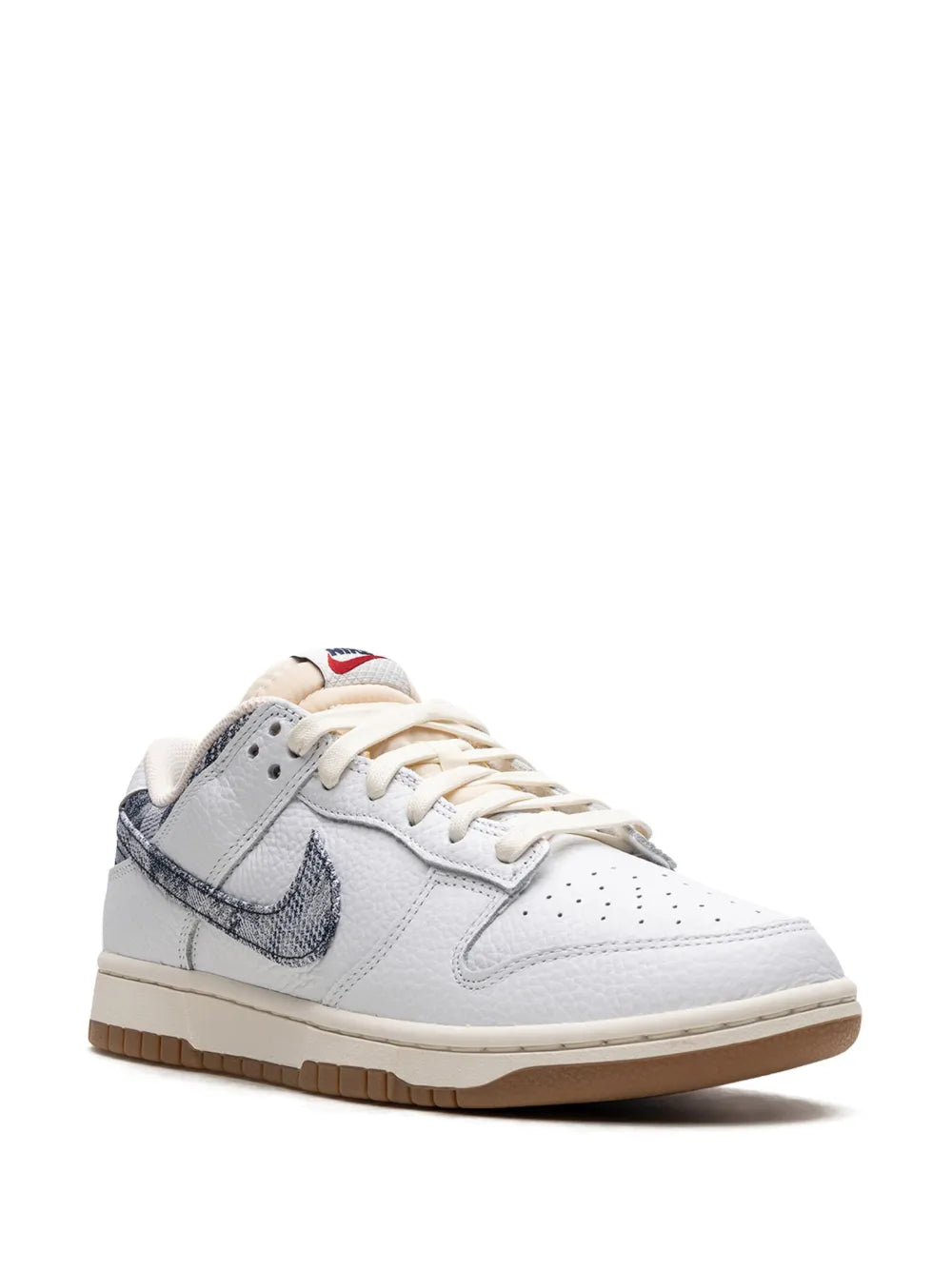 White leather low-top sneaker with navy swoosh and beige-tan lace-up front